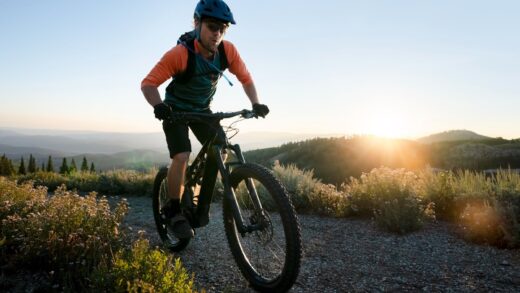 A man riding a bicycle in a field