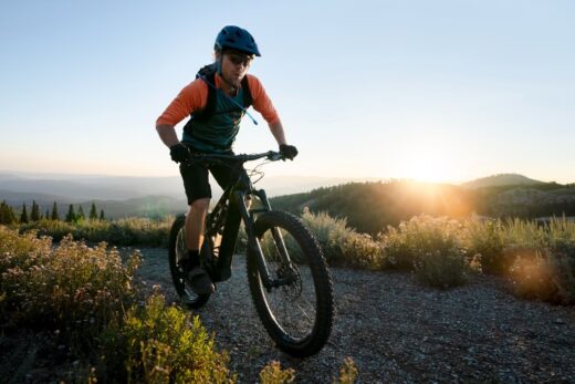 A man riding a bicycle in a field