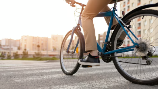 person in brown pants on bicycle rides on the city street